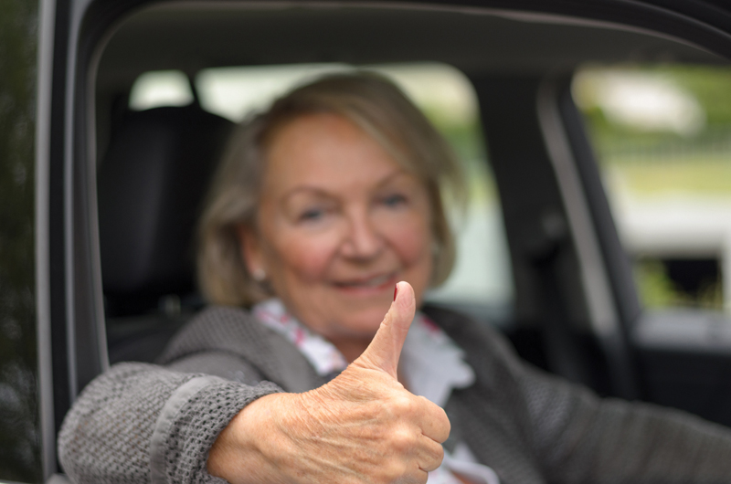 Elderly woman sitting in a car