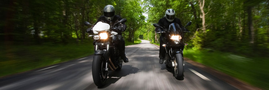 Two motorcycles riding side by side