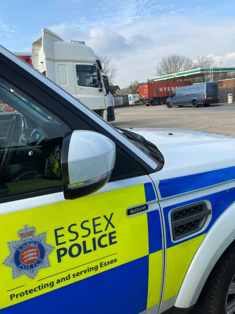 A police car and the HGV cab provided by Highways England