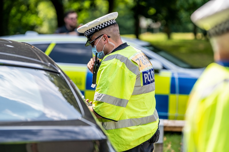 A police officer speaking to a motorist